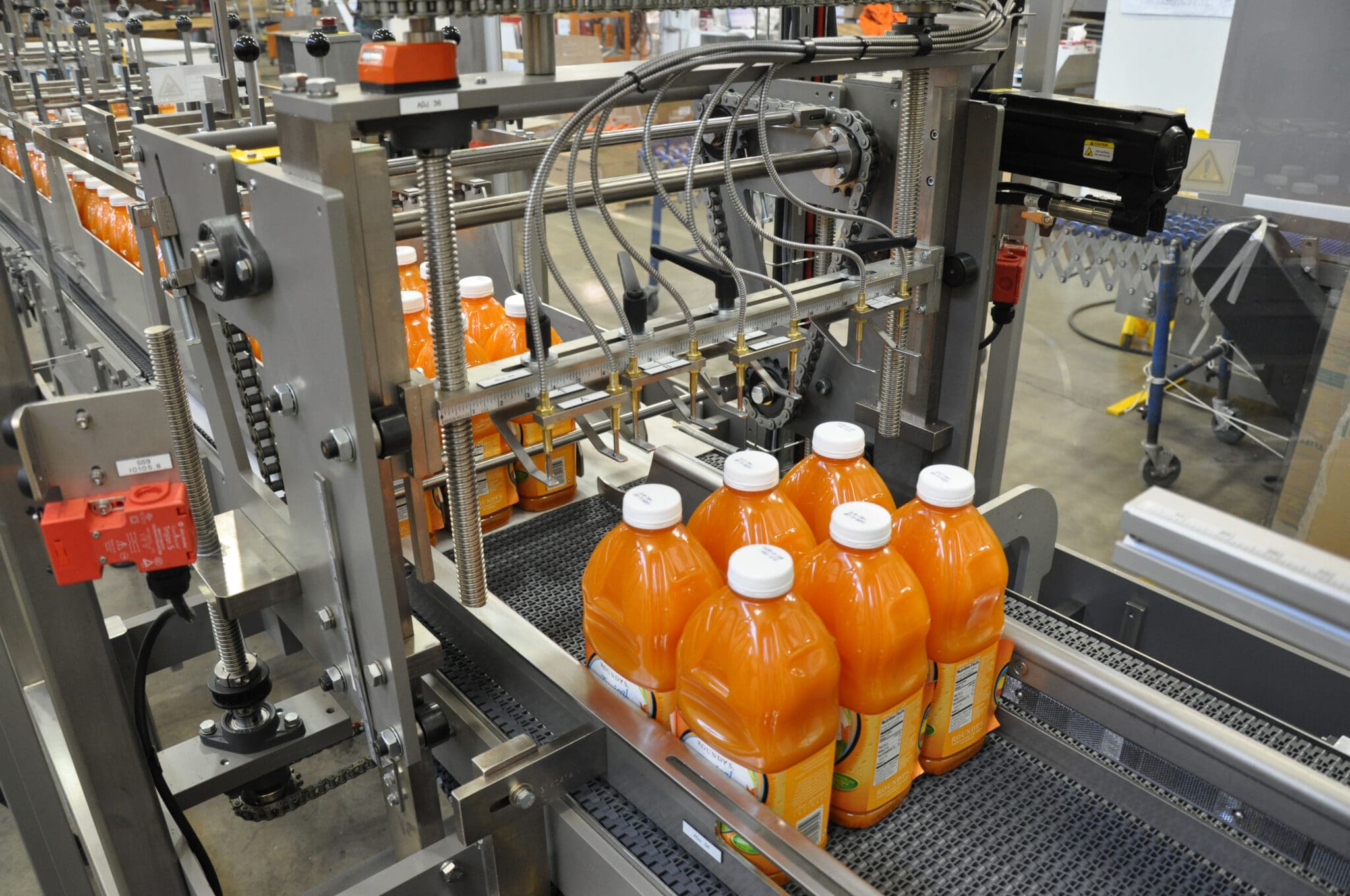 Bottles of juice being metered on a conveyor belt