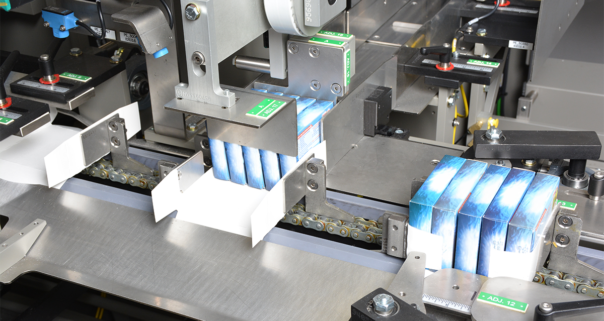 Boxed food products packed into cartons with automated equipment
