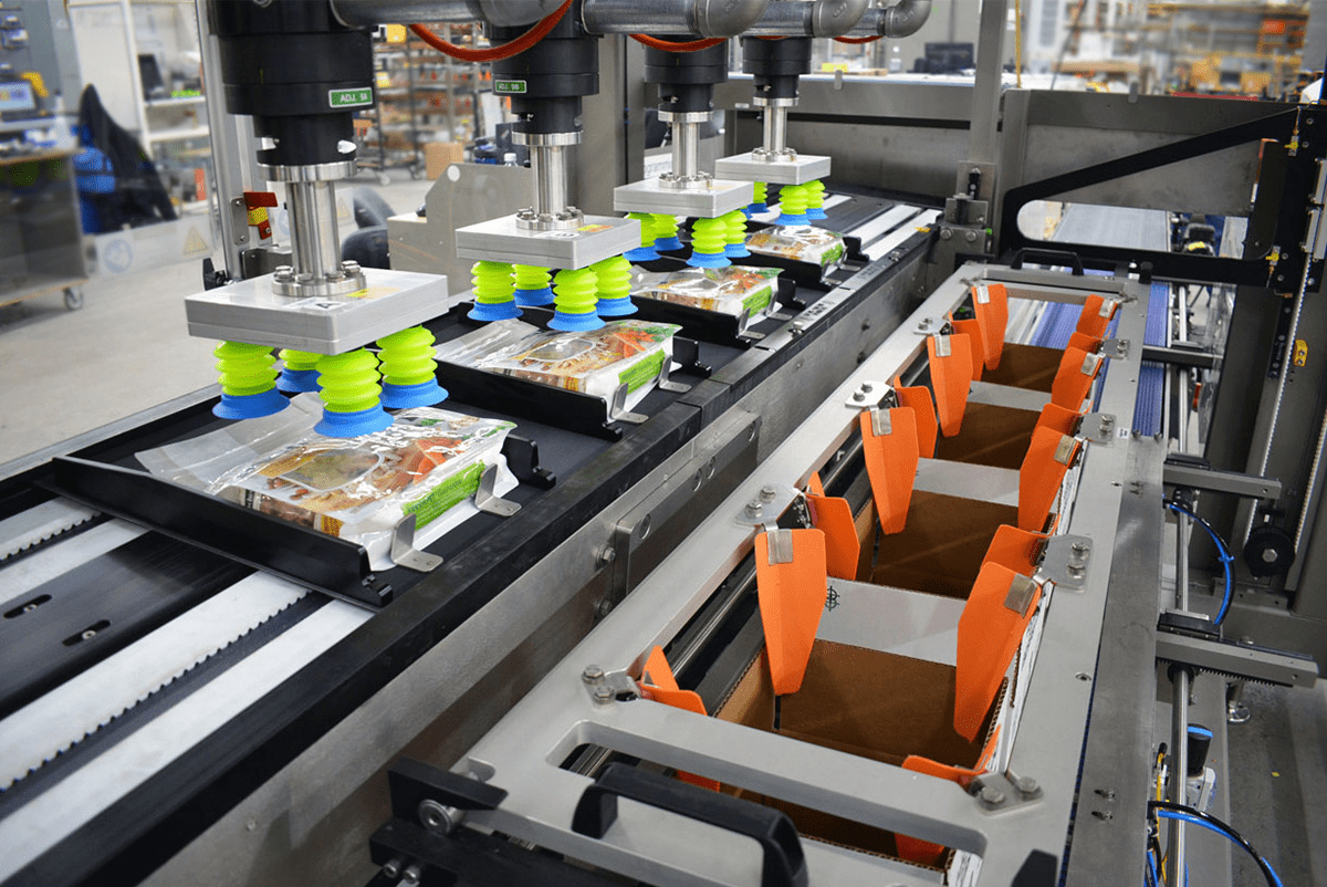 Bags of pet food being loaded into a case