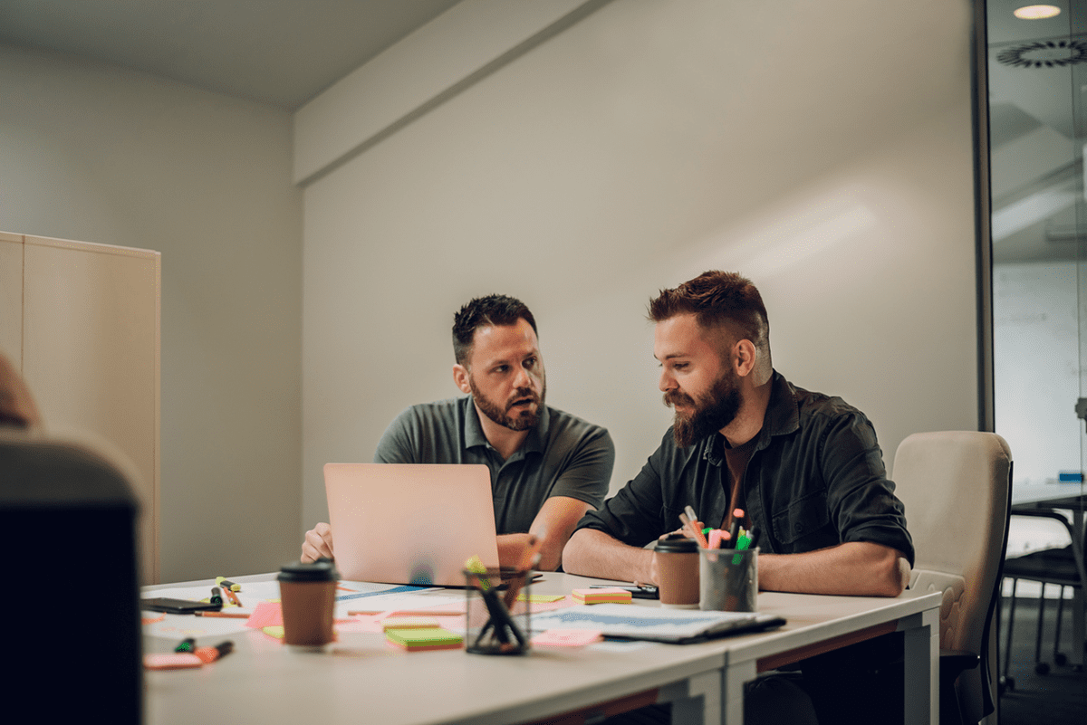 Two engineers collaborating at a desk