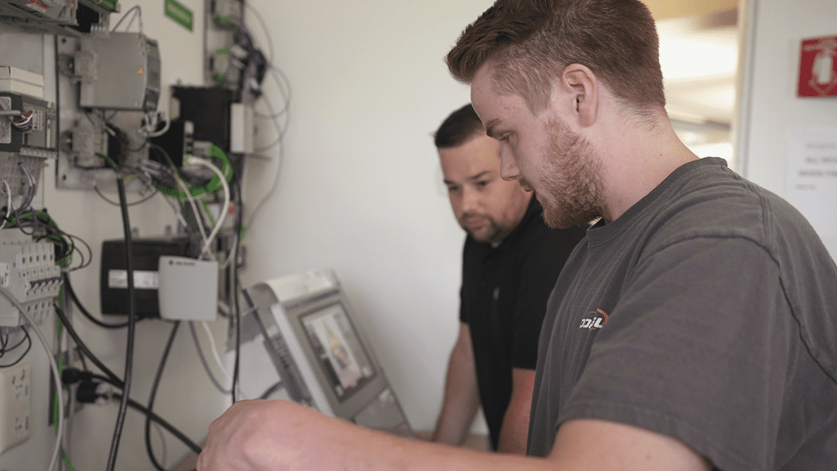 Techinician working on electronic controls for machine