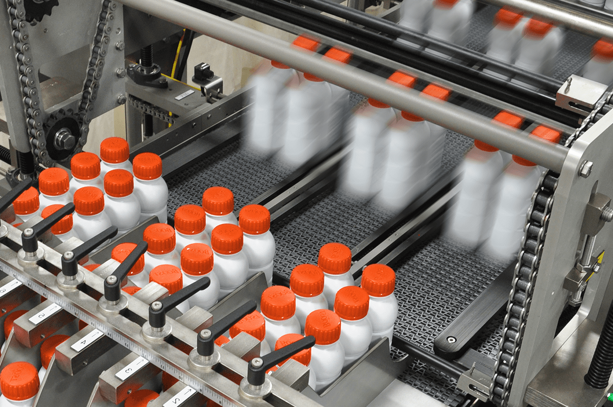 Plastic bottles on conveyor at fast speed