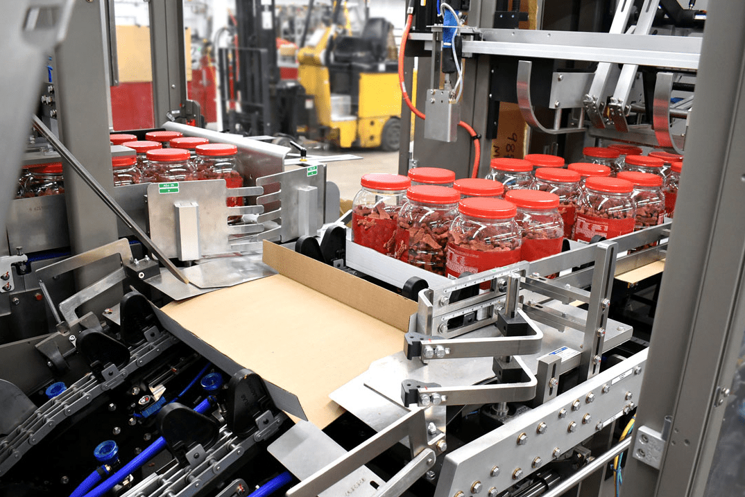 Jars of pet food being packed in trays